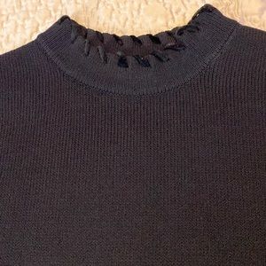 Beautiful St. John black knit shell with zipper neck and velvet ribbon trim.